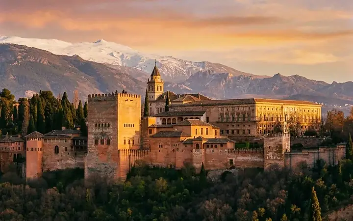 The Alhambra at sunset, with Sierra Nevada behind